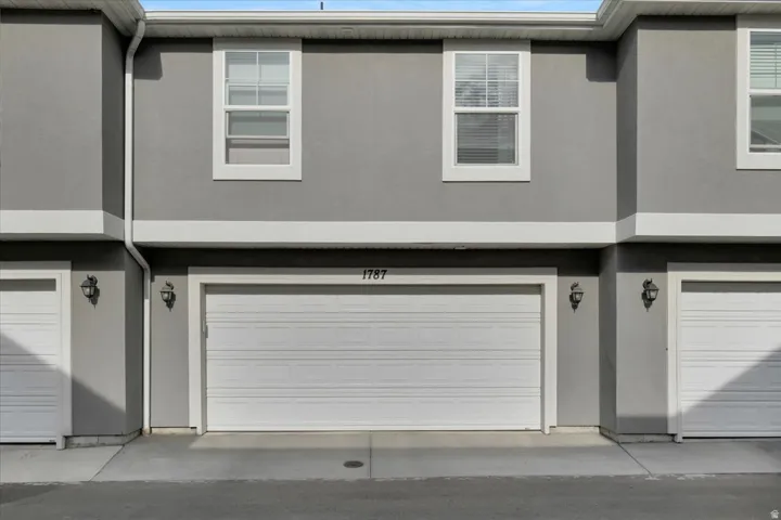 Gray stucco exterior featuring white trim accents