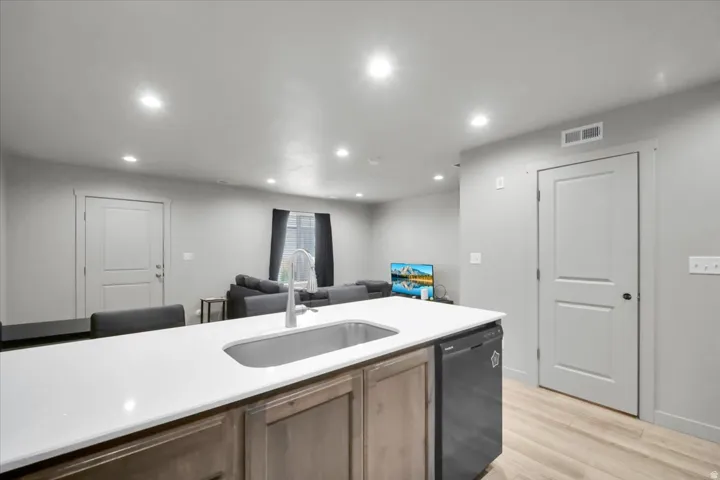 Kitchen island with a white countertop and undermount stainless steel sink