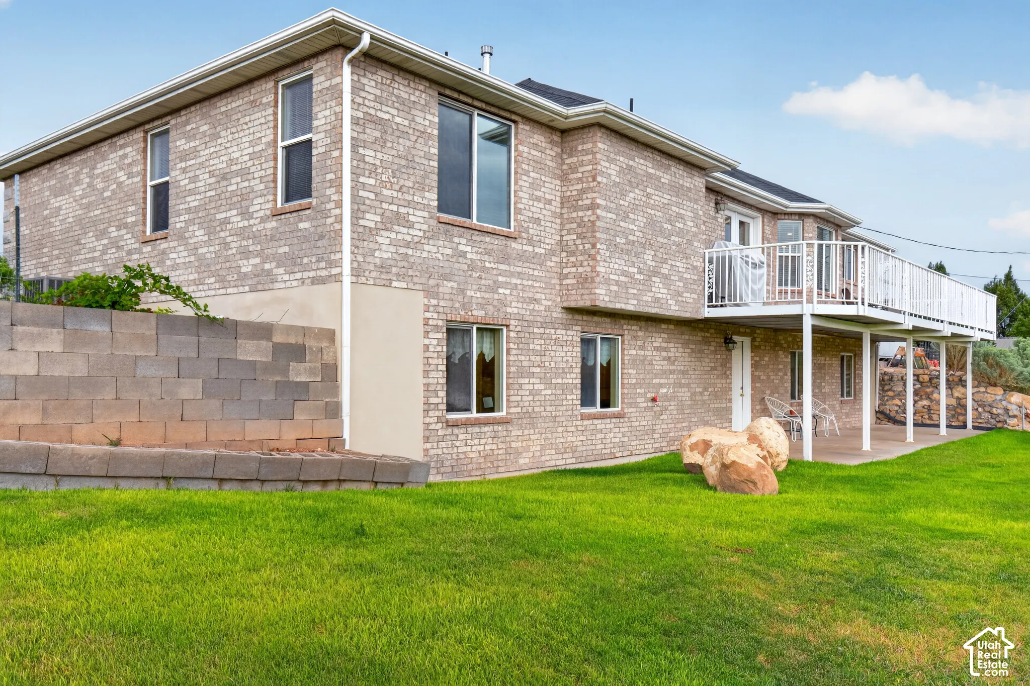 Brick exterior with white trim windows and gutters