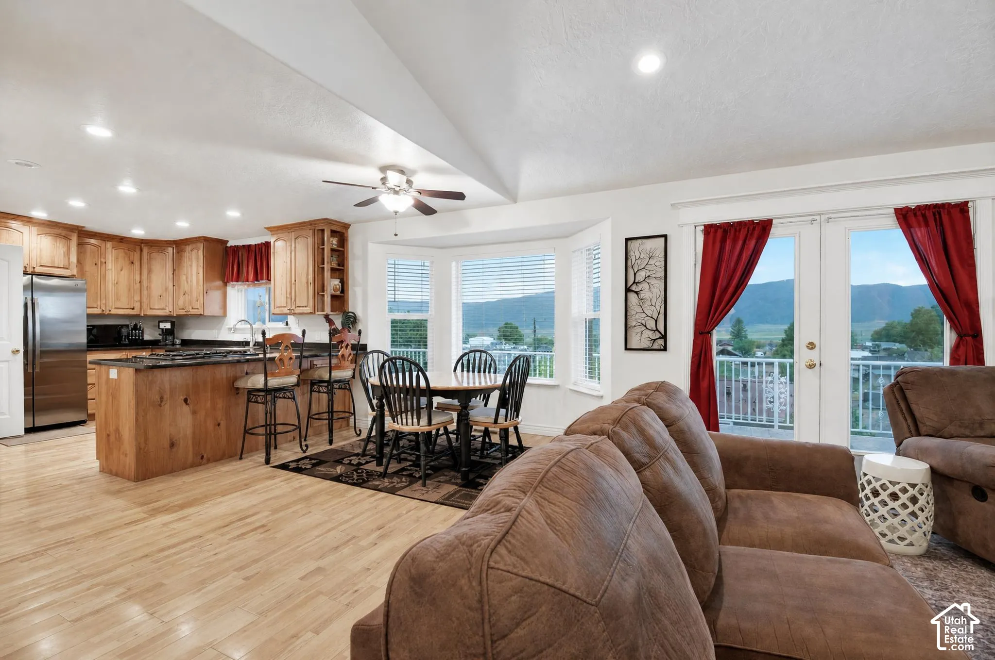 Grear room wit vaulted ceiling and ample natural lighting.  French doors leading to large viewing deck