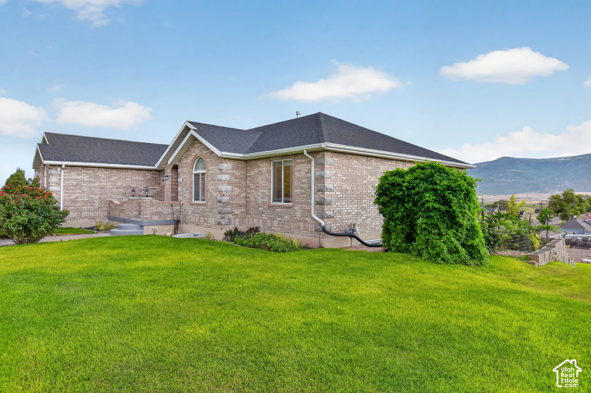 Light brick exterior with contrasting dark roof shingles