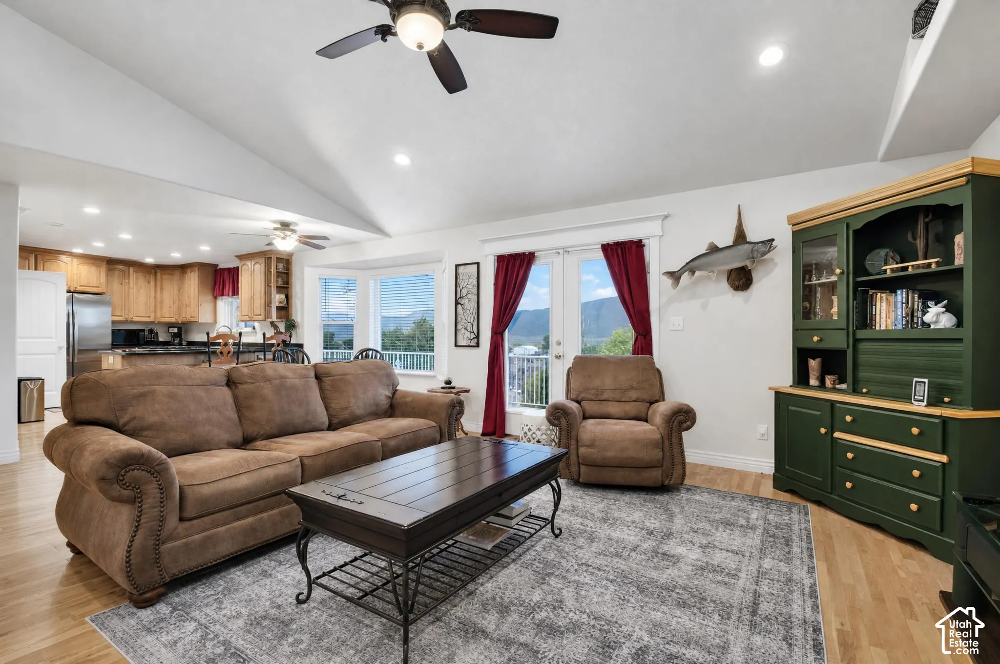 Grear room wit vaulted ceiling and ample natural lighting.  French doors leading to large viewing deck