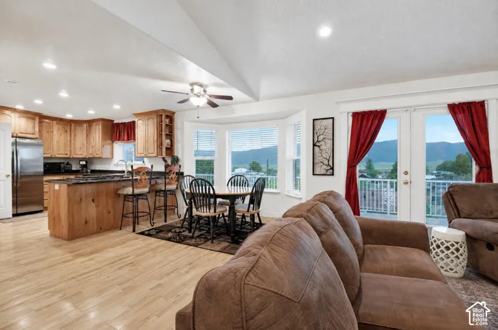 Grear room wit vaulted ceiling and ample natural lighting.  French doors leading to large viewing deck
