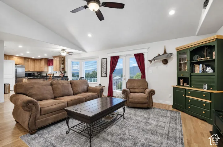 Grear room wit vaulted ceiling and ample natural lighting.  French doors leading to large viewing deck