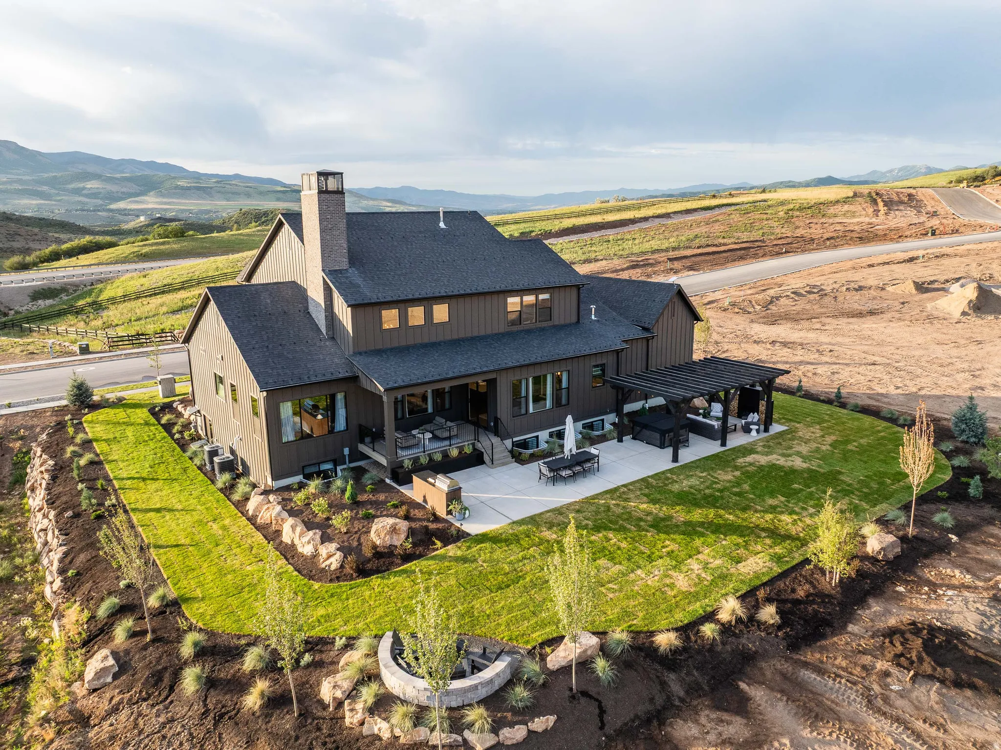 Modern farmhouse architecture featuring dark siding and a dark shingled roof