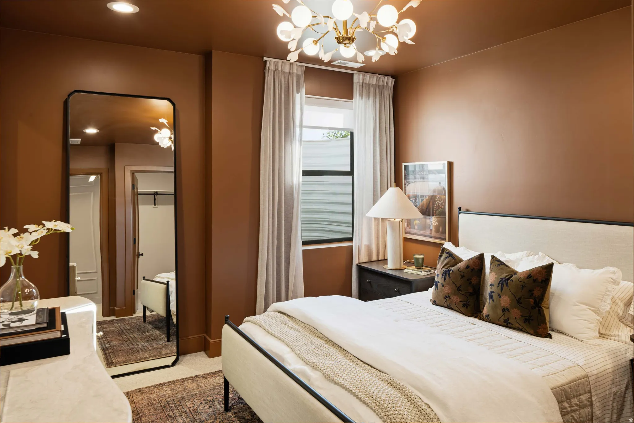 Bedroom featuring warm brown walls, a contemporary chandelier, recessed lighting, and a window with light-filtering drapes