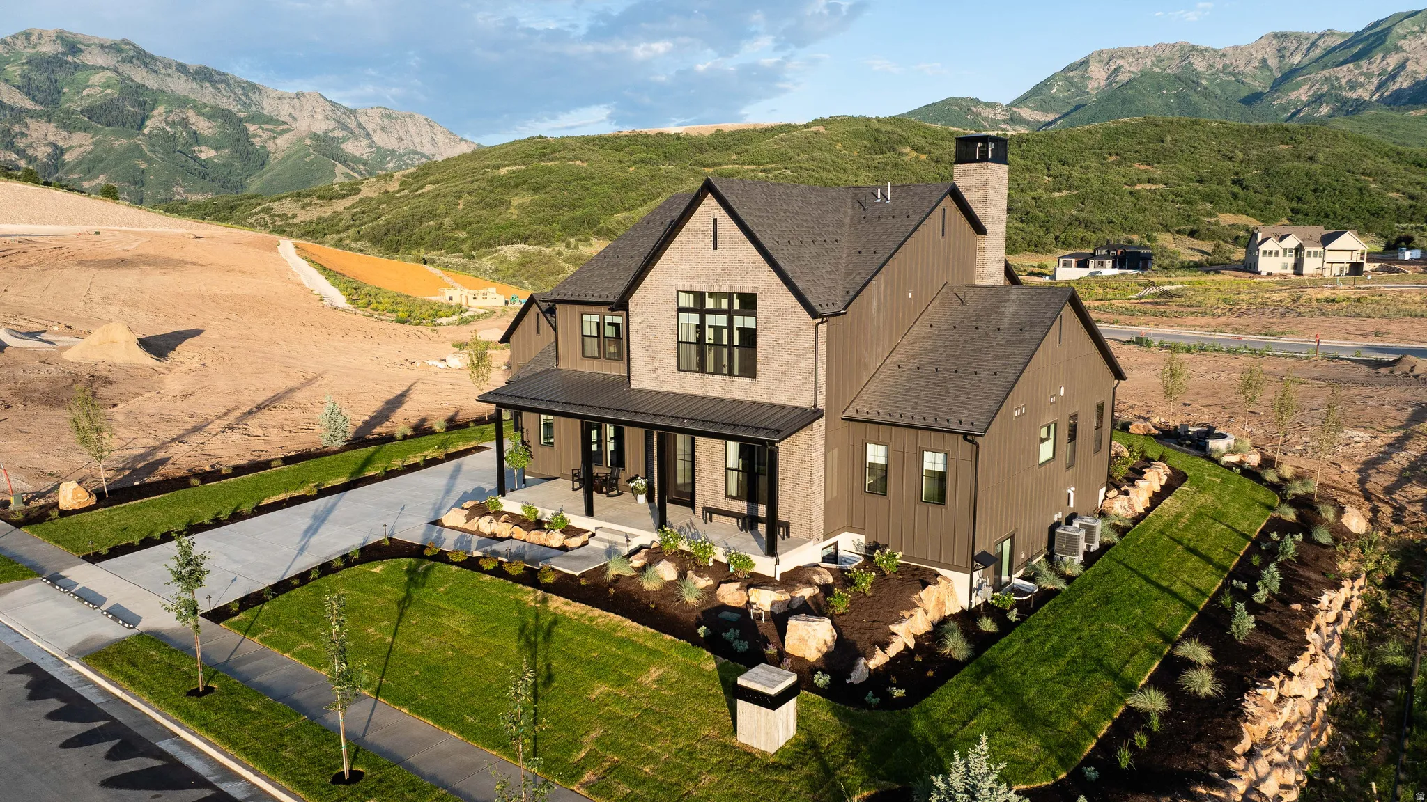Modern farmhouse-style residence with a dark-toned brick and vertical siding exterior