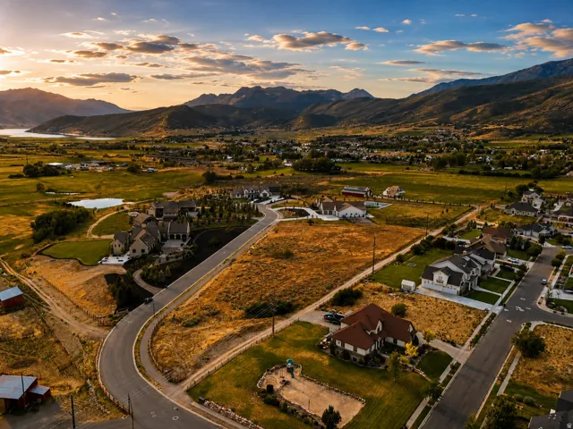 Expansive aerial view of a developing residential area with paved streets and established homes
