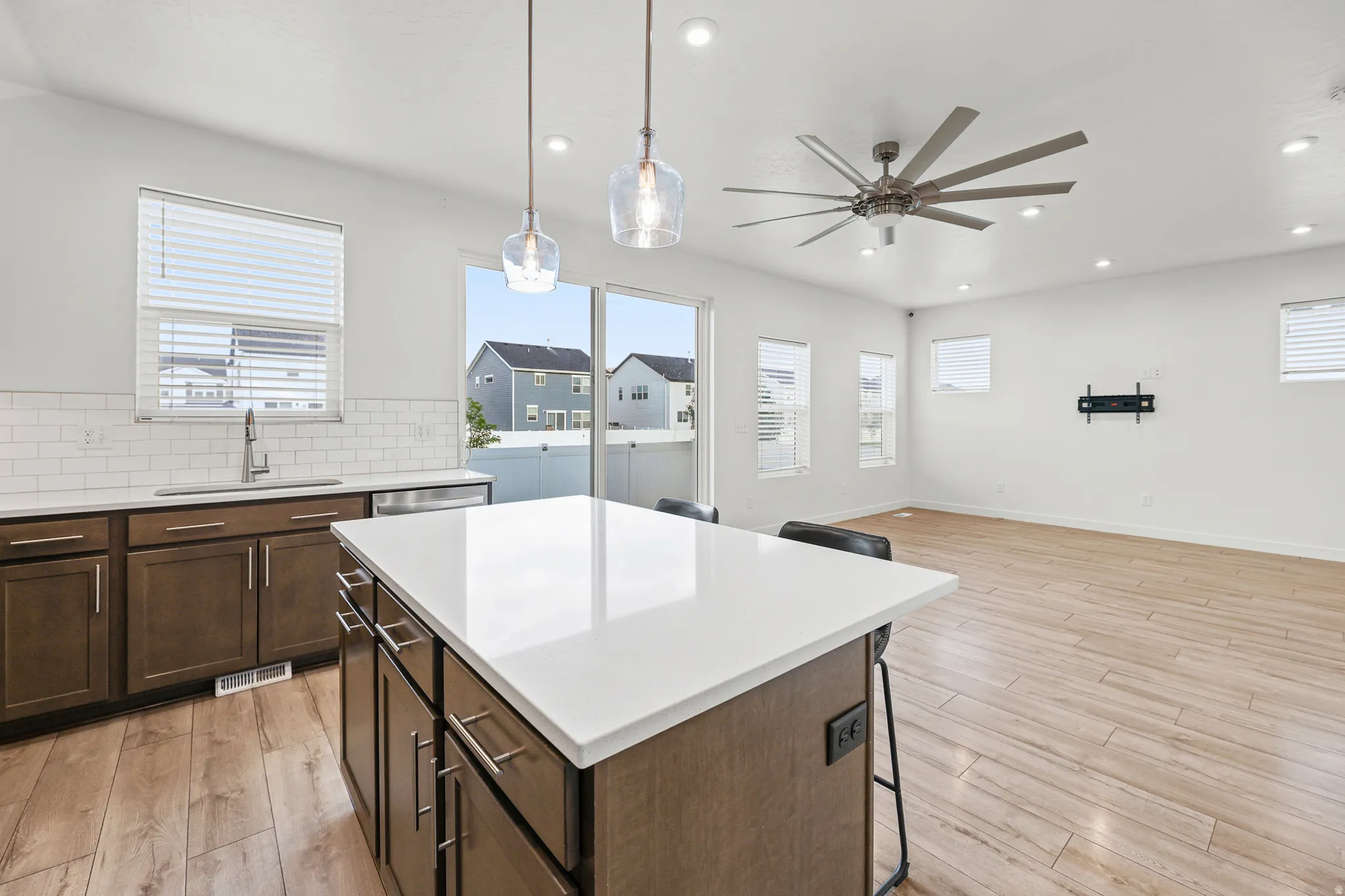 Open concept living area featuring wood-finish flooring