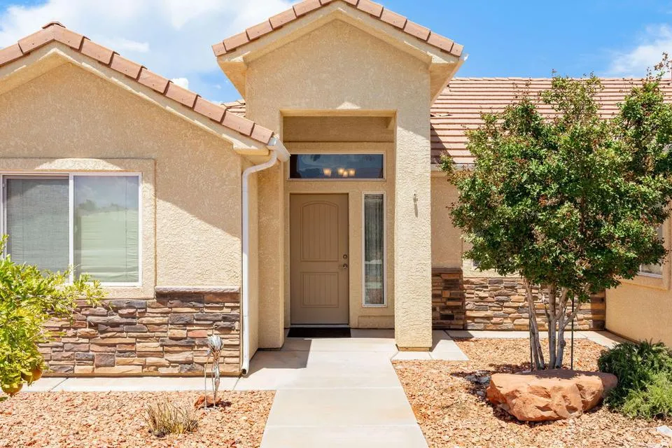 Entryway featuring a decorative front door with transom window and sidelight