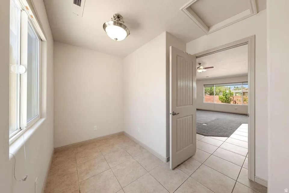 Neutral interior space featuring tile flooring and a single-pane window