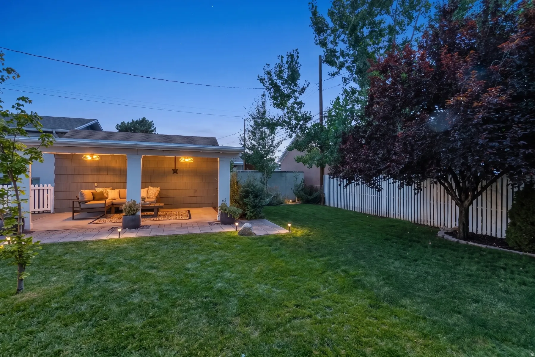 Covered patio with recessed lighting and paver flooring, featuring a shingle-sided exterior