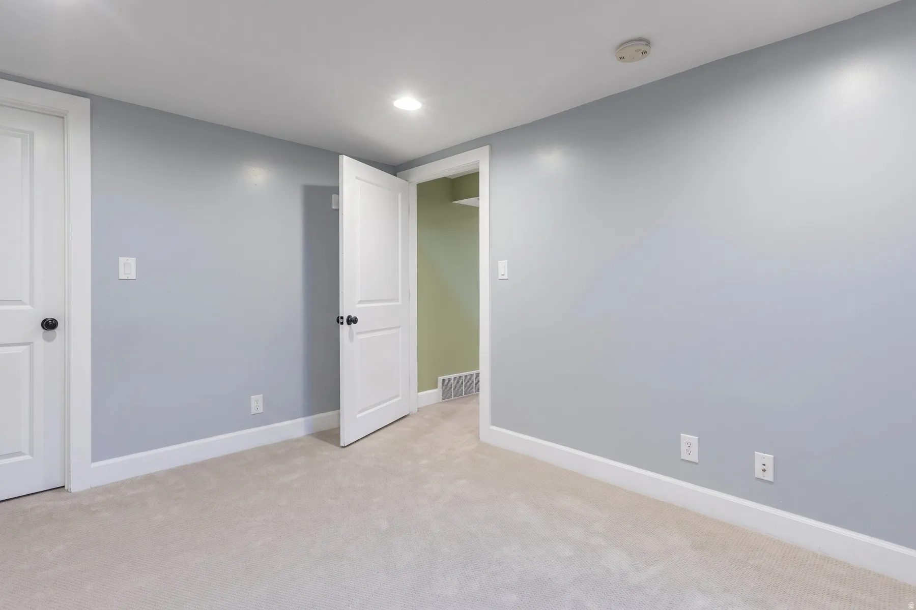 Neutral-toned carpeting paired with light blue walls