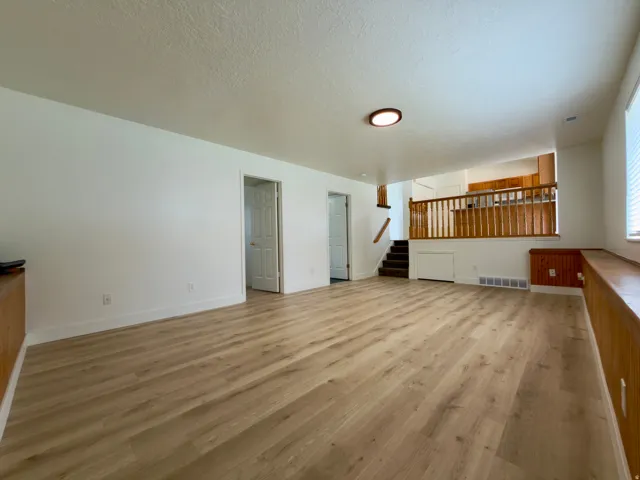 Spacious family room featuring LVP flooring, & wooden ledge