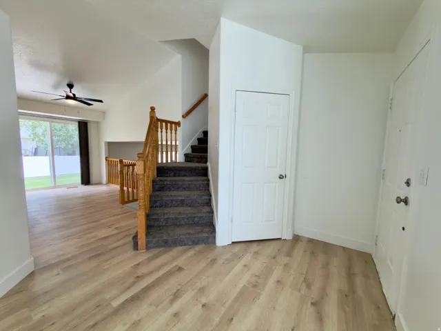 Entryway featuring LVP flooring, a coat closet & front door