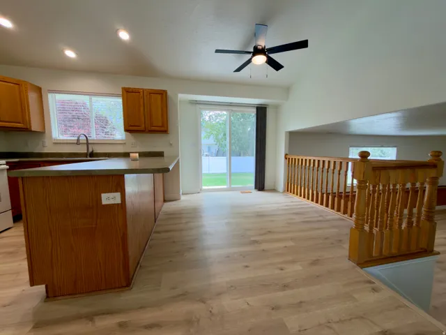 Open-concept kitchen and dining area featuring LVP flooring, recessed lighting, and a ceiling fan
