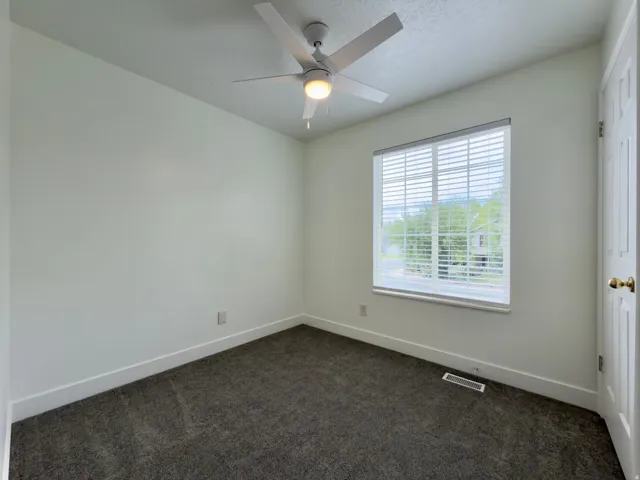 Top floor bedroom with ceiling fan