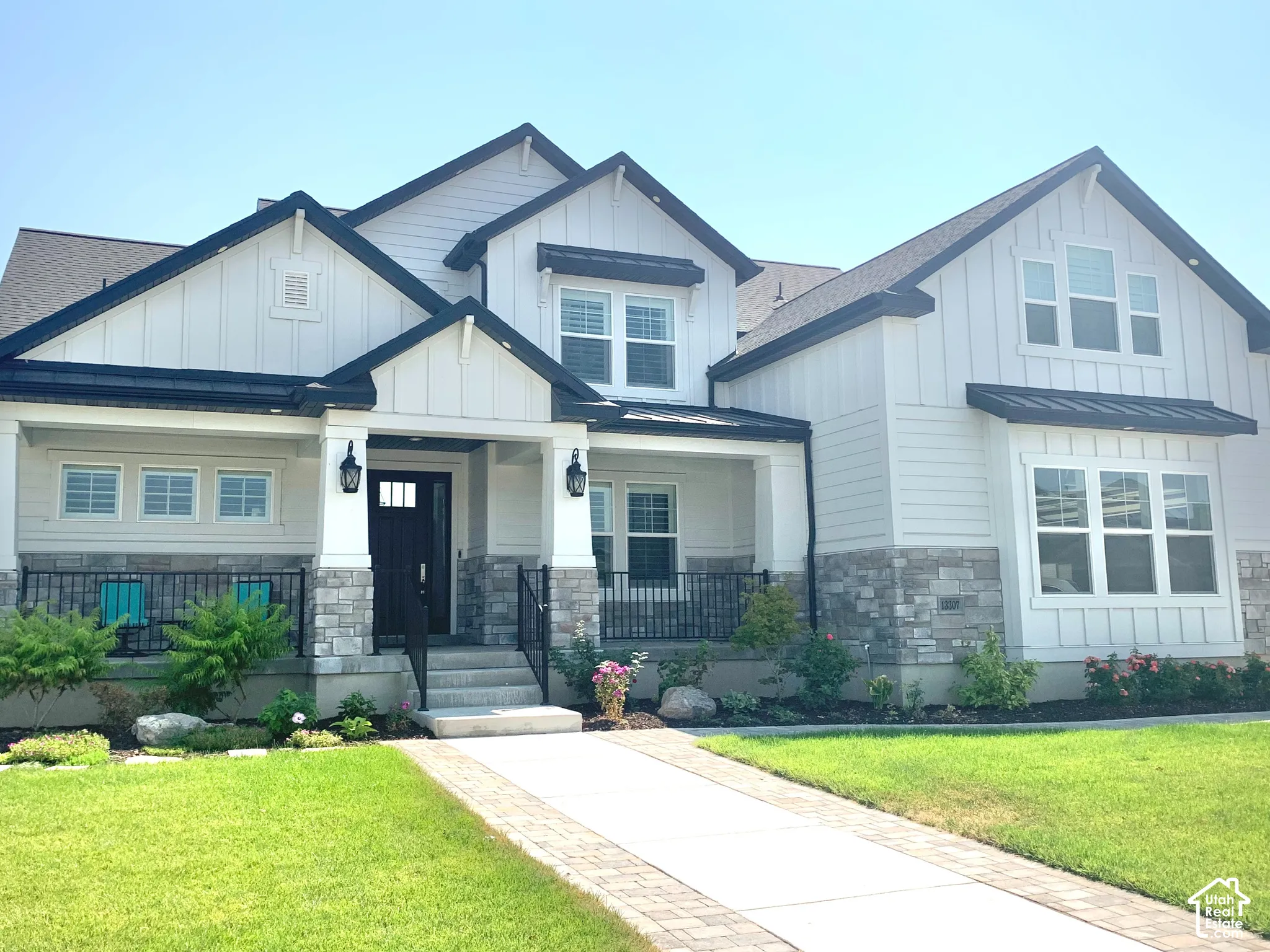 Modern Farmhouse exterior with white board-and-batten siding and stone accents