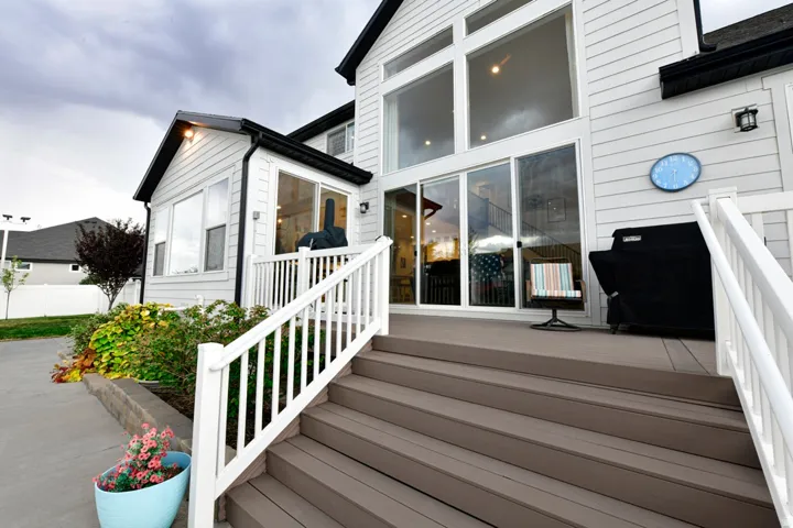 Expansive rear deck with composite flooring and white railings
