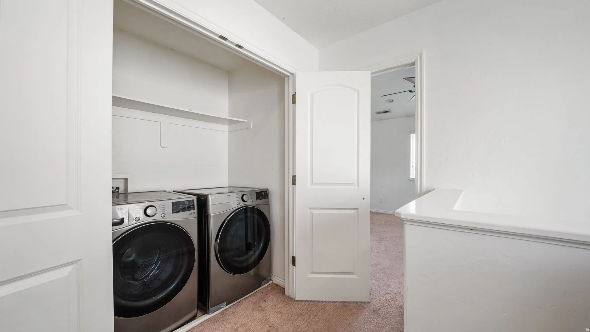 Dedicated laundry closet with shelving