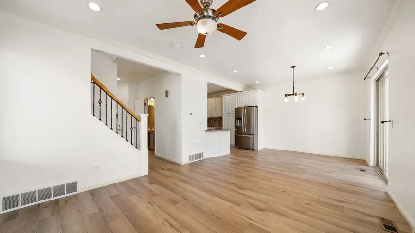 Open concept living space featuring wood-finish flooring, recessed lighting, and a modern ceiling fan