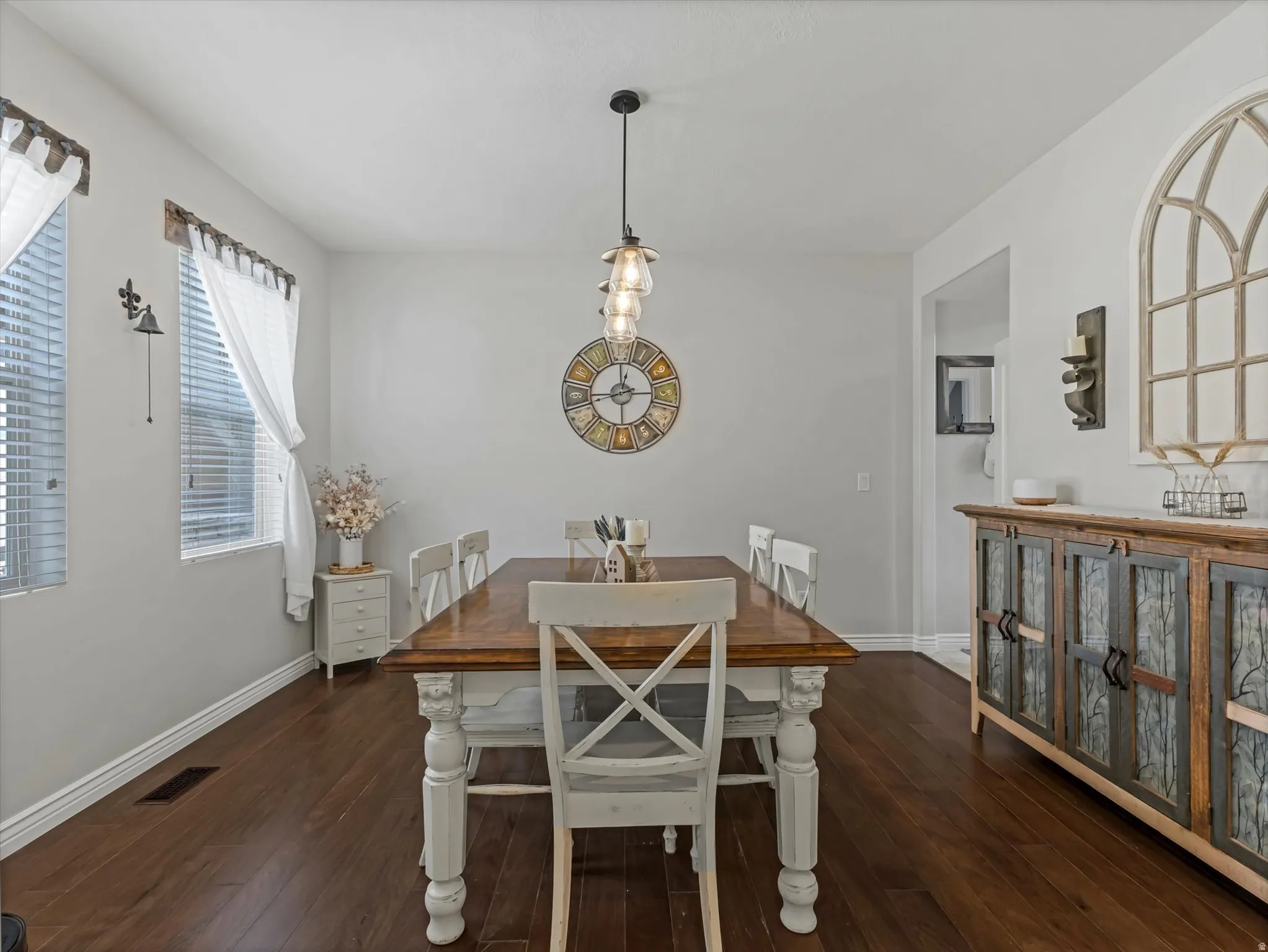 Dining area featuring rich, dark wood-finish flooring