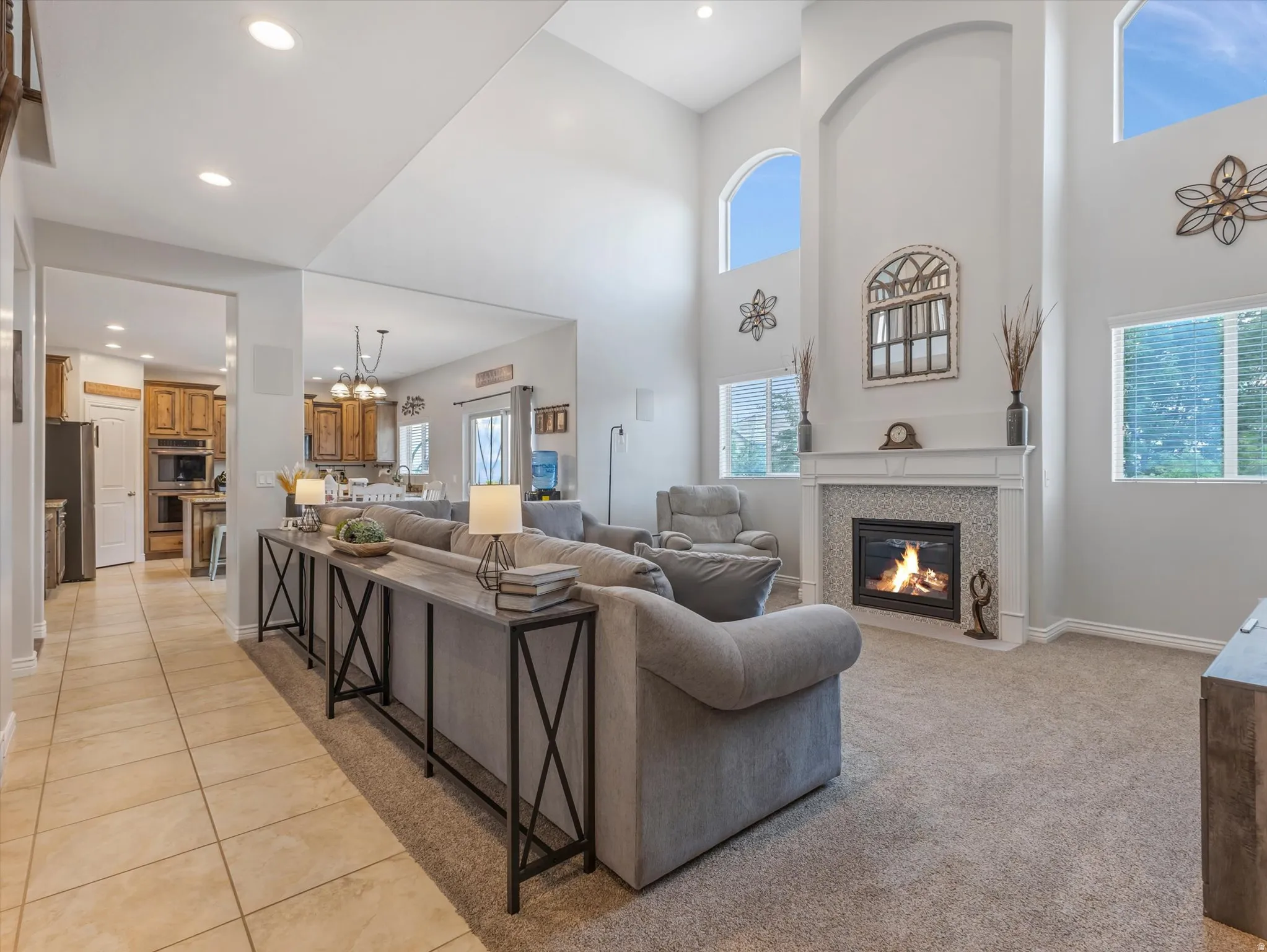Great room with vaulted ceilings and abundant natural light from high arched windows