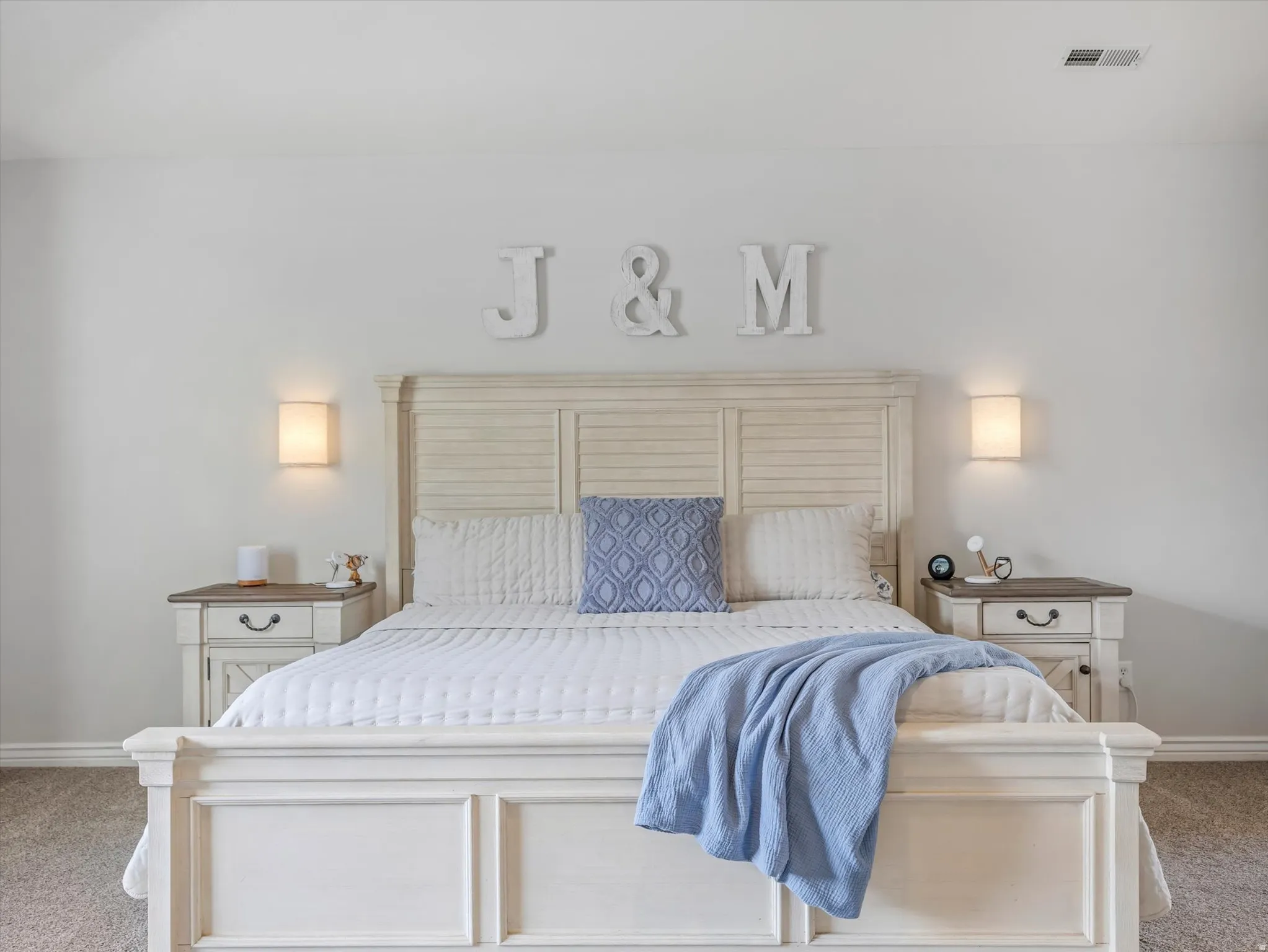 Bedroom featuring light-colored walls and carpet flooring