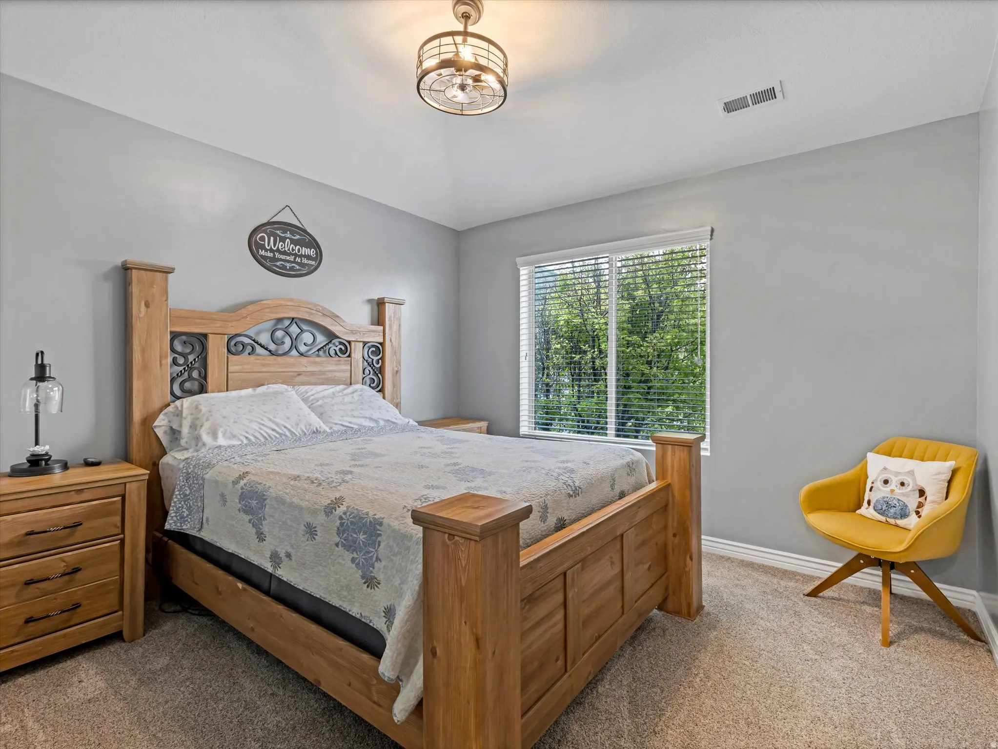 Carpeted room with light gray walls and a single window featuring horizontal blinds