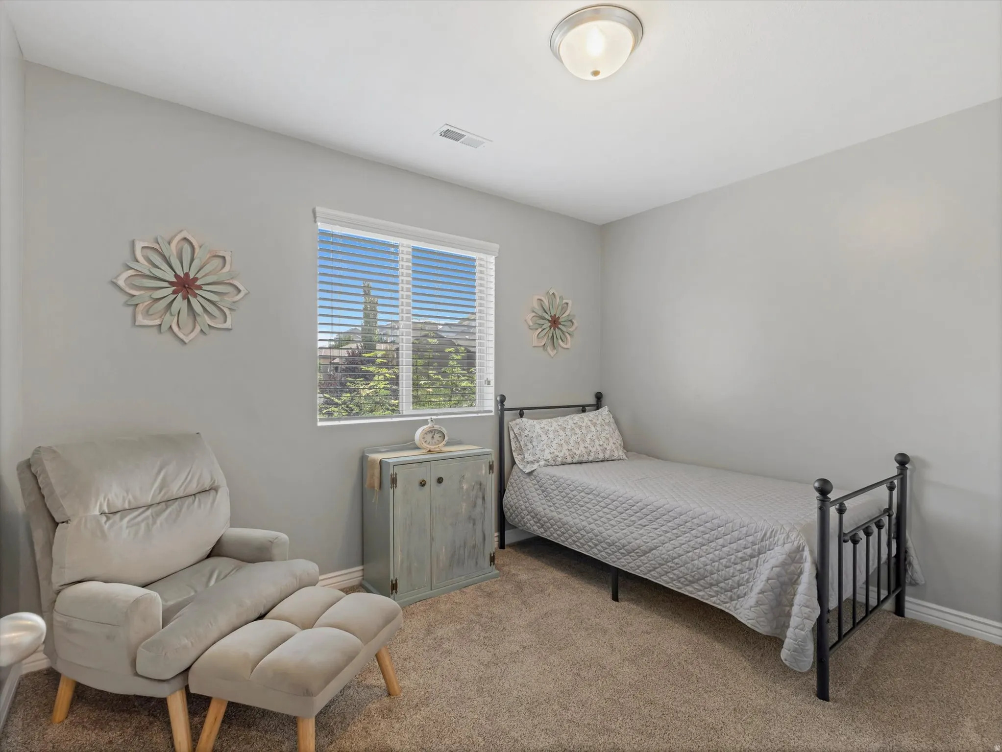 Carpeted room featuring light gray wall paint, a window with horizontal blinds, and a flush-mount ceiling light fixture