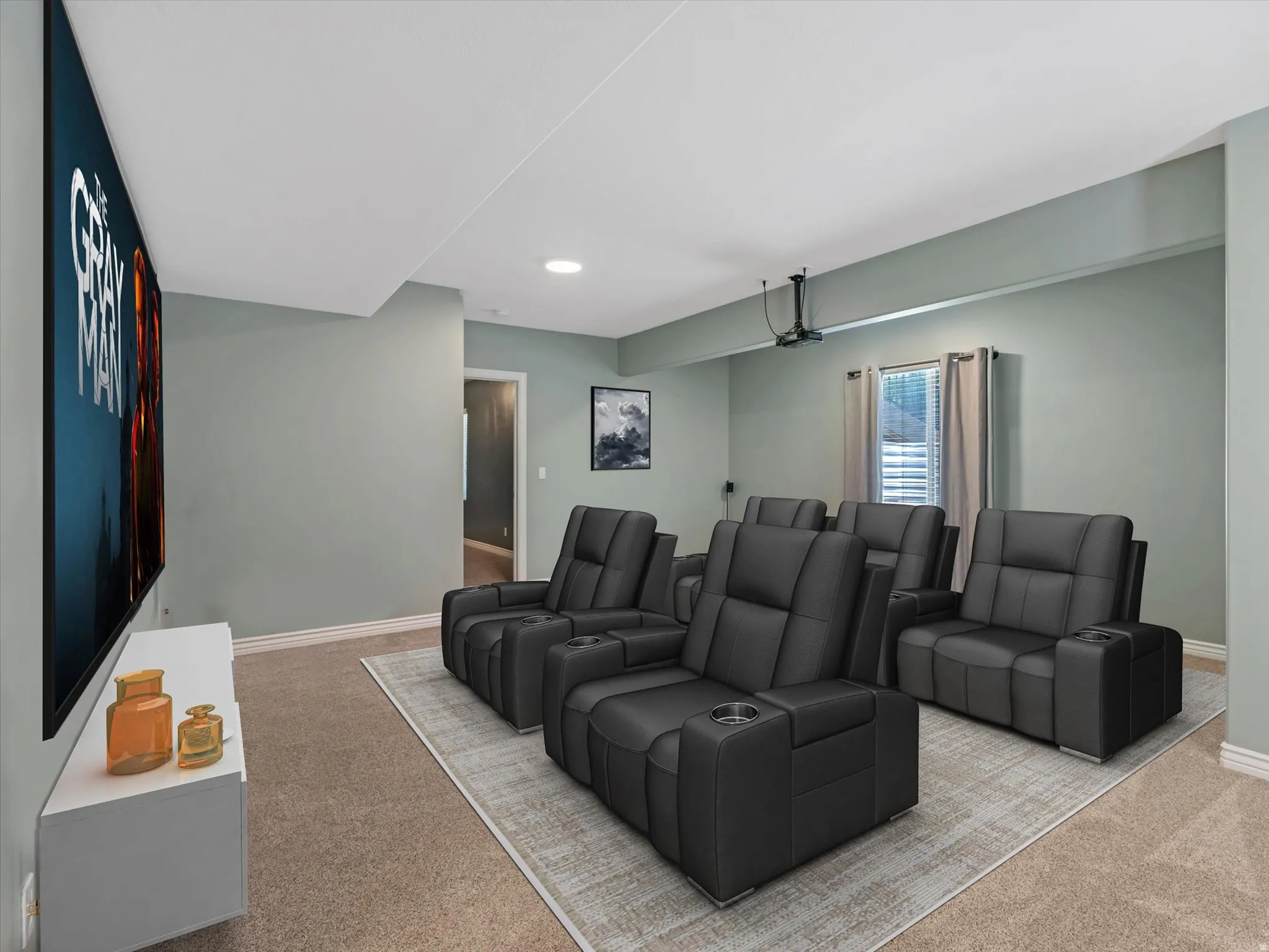 Dedicated entertainment room featuring a large projection screen and recessed lighting