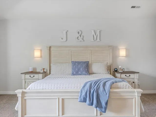 Bedroom featuring light-colored walls and carpet flooring