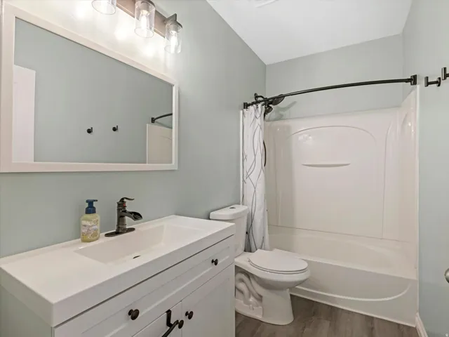 Bathroom featuring a white vanity with integrated sink, bronze-finish faucet, and coordinating bronze-finish light fixture