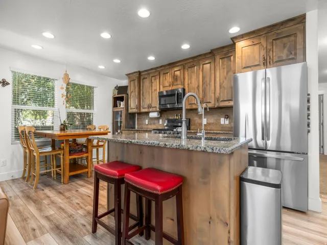 Kitchen featuring wood-finish cabinetry, granite countertops, and stainless steel appliances
