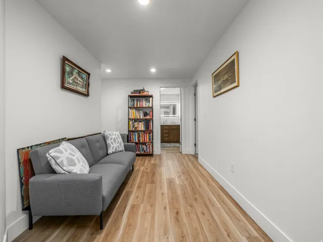 Long, bright hallway featuring recessed lighting and wood-finish flooring