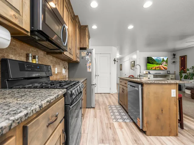 Well-appointed kitchen featuring wood-finish flooring and recessed lighting
