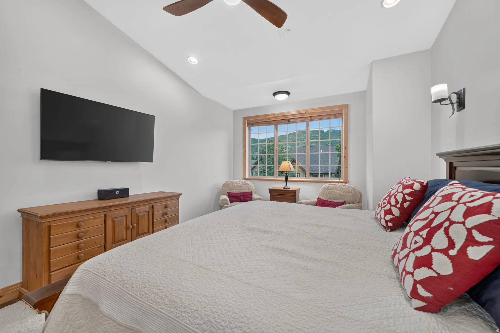 Bedroom featuring a large window with mountain scenery, a vaulted ceiling, recessed lighting, and a dark wood ceiling fan