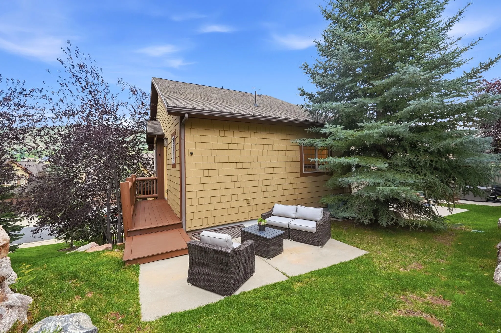 Exterior featuring horizontal siding, a gabled roof, and an outdoor patio area