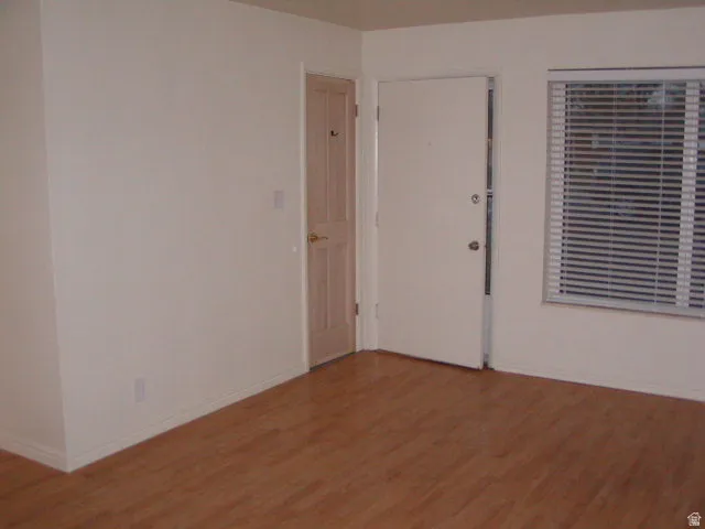 Light wood-finish flooring complements neutral wall tones
