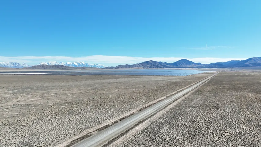 Expansive desert landscape with a clear blue sky overhead