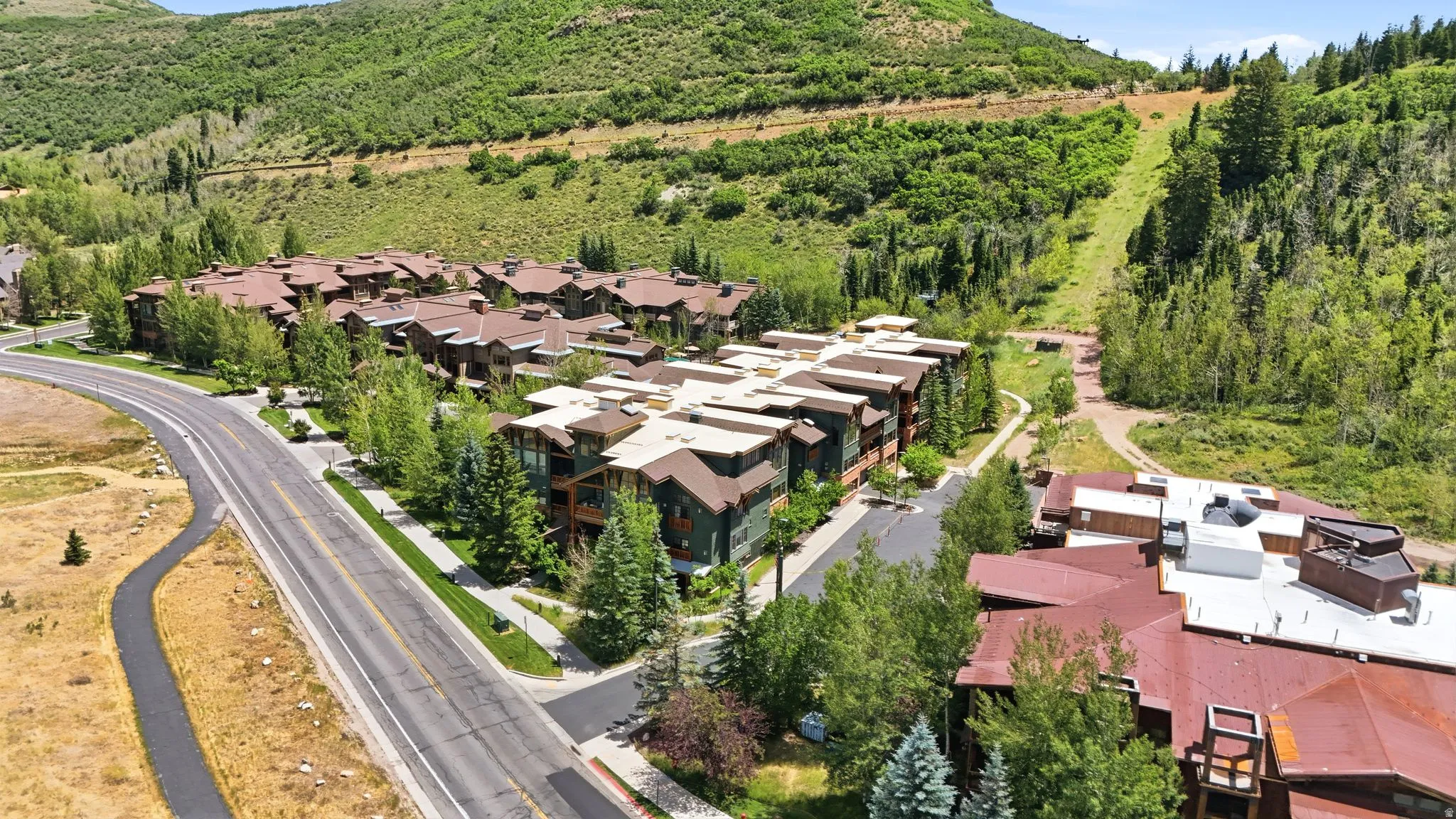 Modern multi-unit development with a multi-level design and a combination of natural wood and stone facades