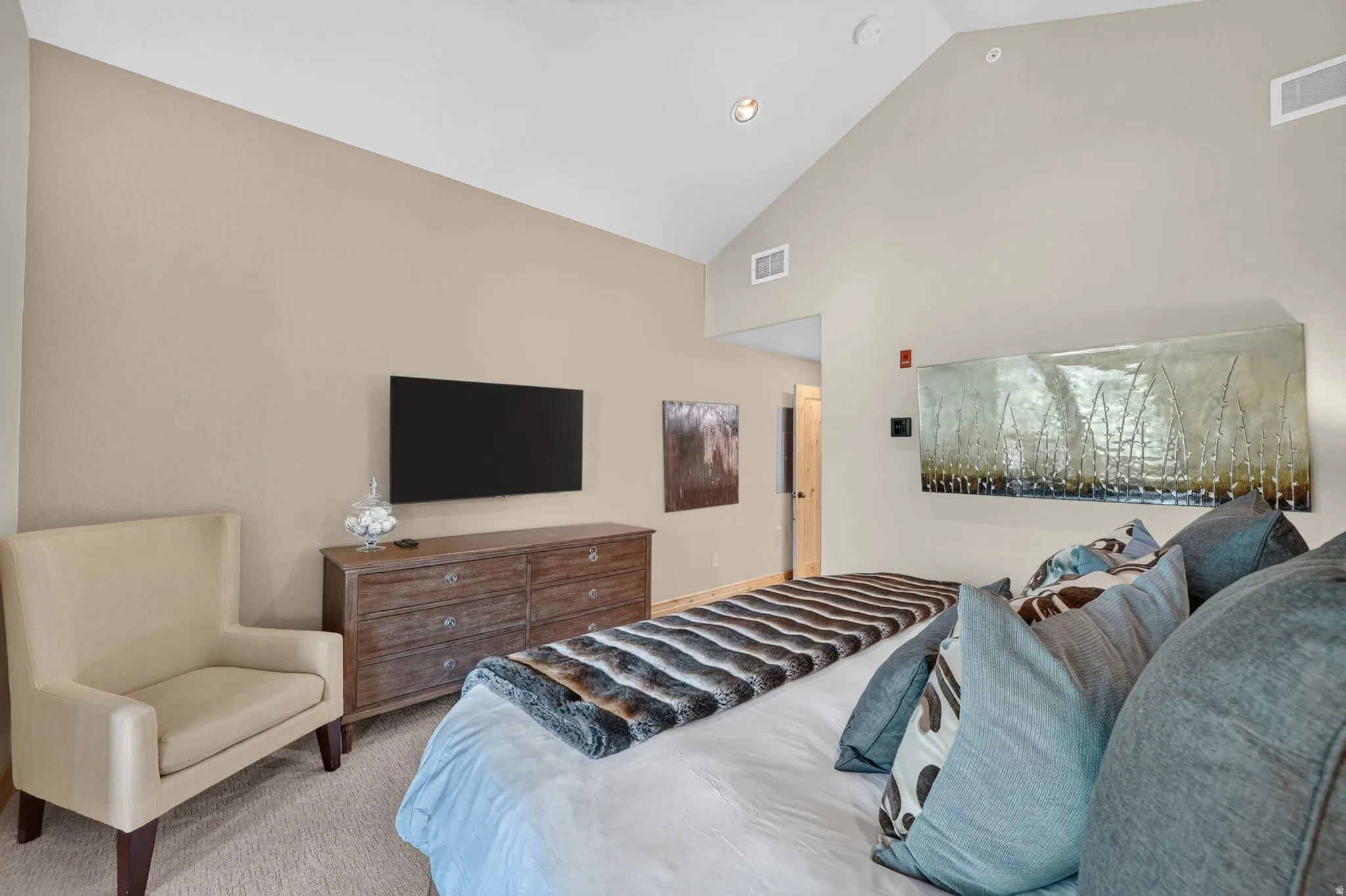 Room featuring vaulted ceilings and recessed lighting