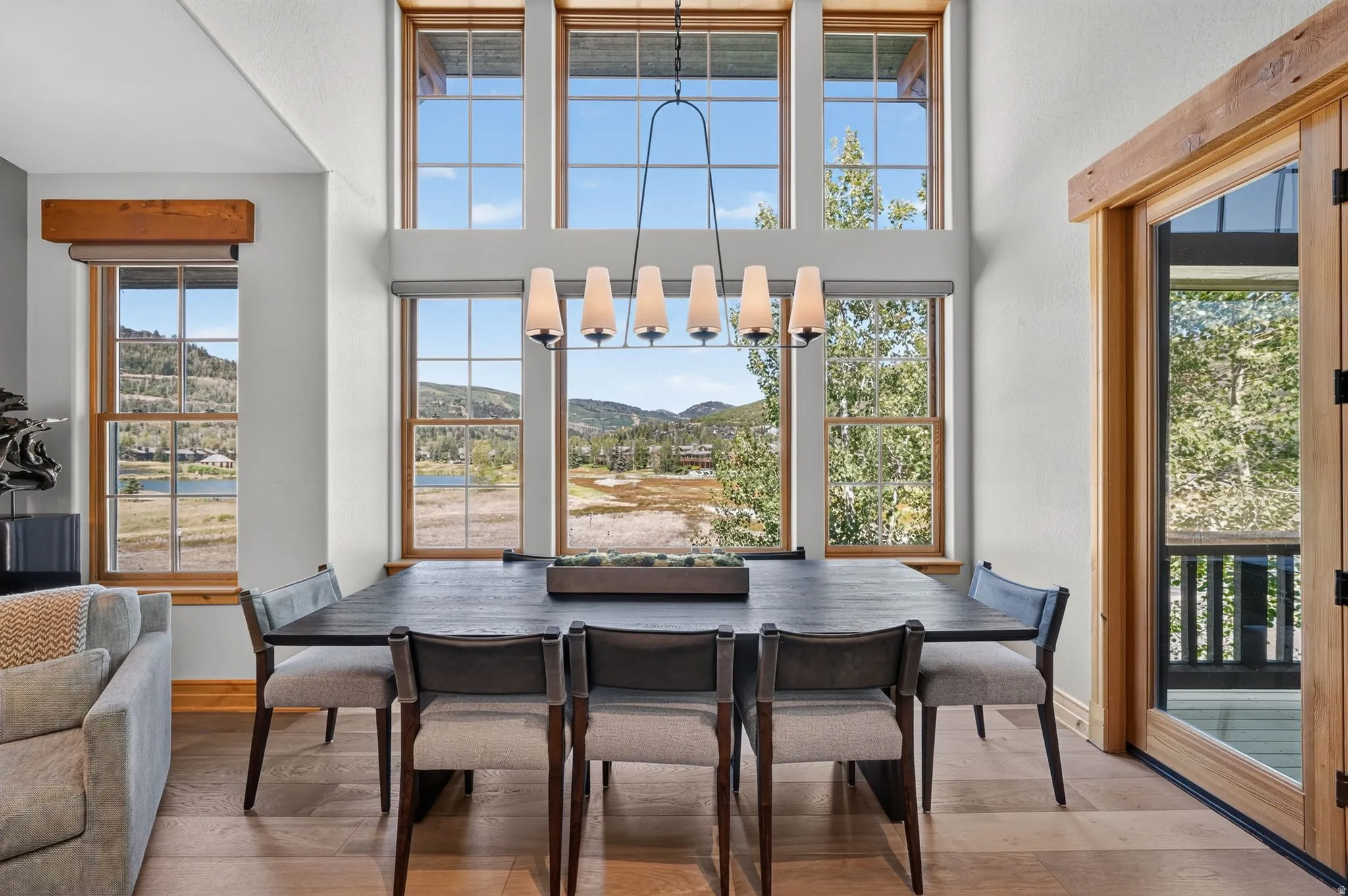 Expansive window wall with natural wood framing, offering elevated natural scenery