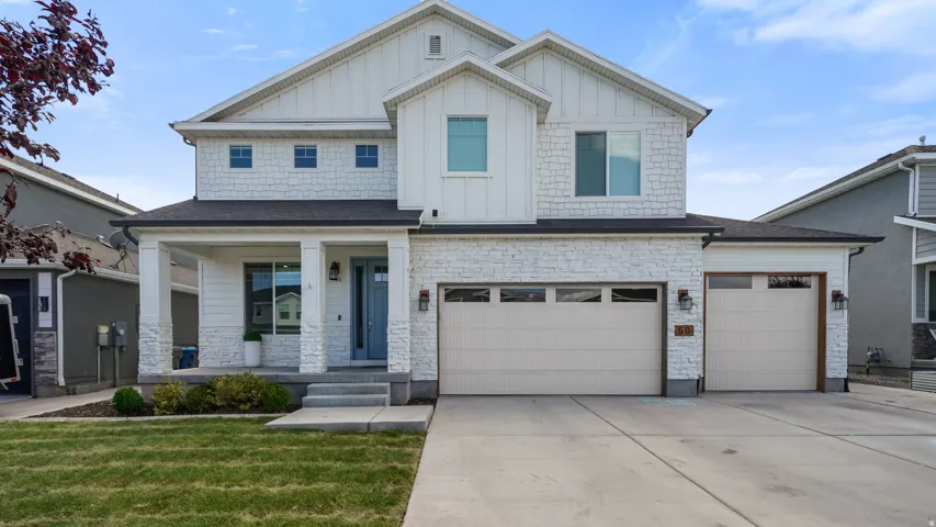 Contemporary-style residence featuring a three-car garage and an additional single-car garage