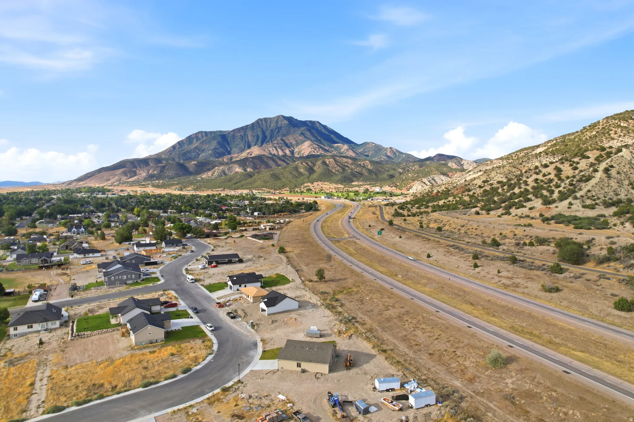 New construction residential development featuring cul-de-sac streets and mountain backdrops
