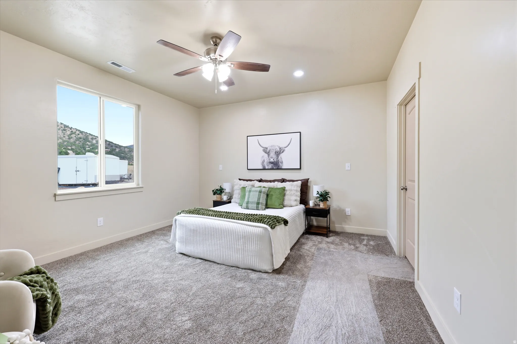 Bedroom featuring neutral-toned walls, recessed lighting, and a ceiling fan with integrated lighting
