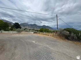 Gravel road access with mountainous backdrop