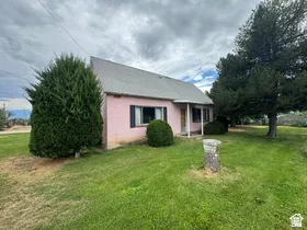 Pink exterior siding with a gray gabled roof