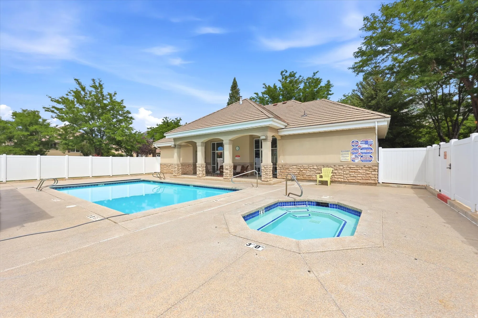 HOA Outdoor aquatic area featuring a rectangular swimming pool and a separate hexagonal spa