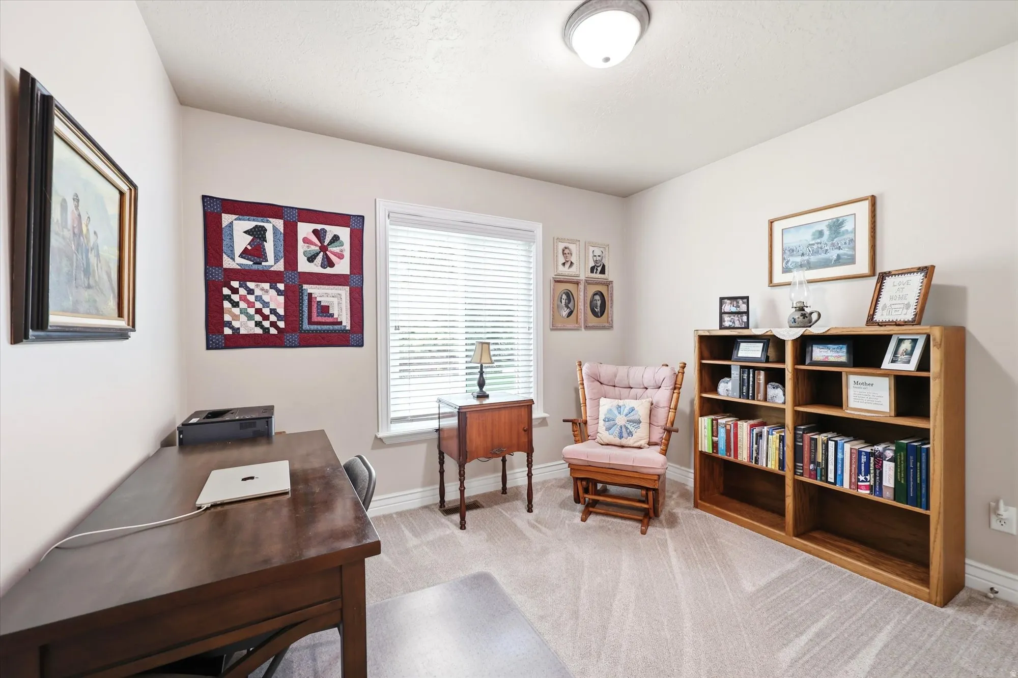 Carpeted room featuring a window with blinds, recessed lighting, and built-in shelving units
